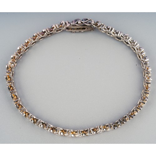 59 - A boxed silver and CZ line tennis bracelet; a silver charm bracelet and a framed collection of silve... 