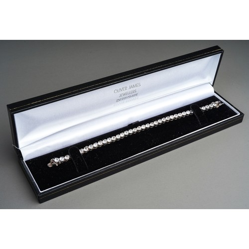 59 - A boxed silver and CZ line tennis bracelet; a silver charm bracelet and a framed collection of silve... 