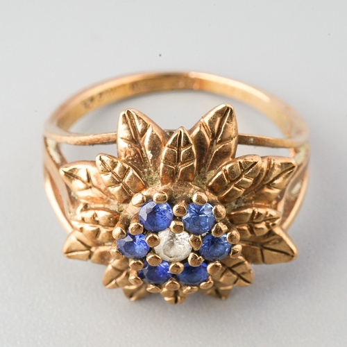 69 - A 9ct yellow gold sapphire cluster ring, set with a colourless sapphire, surrounded by six blue sapp... 