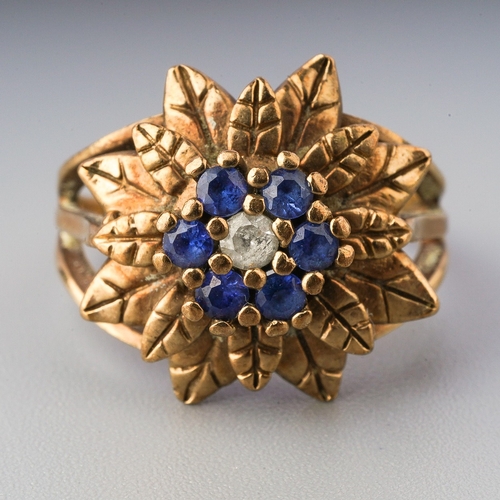 69 - A 9ct yellow gold sapphire cluster ring, set with a colourless sapphire, surrounded by six blue sapp... 