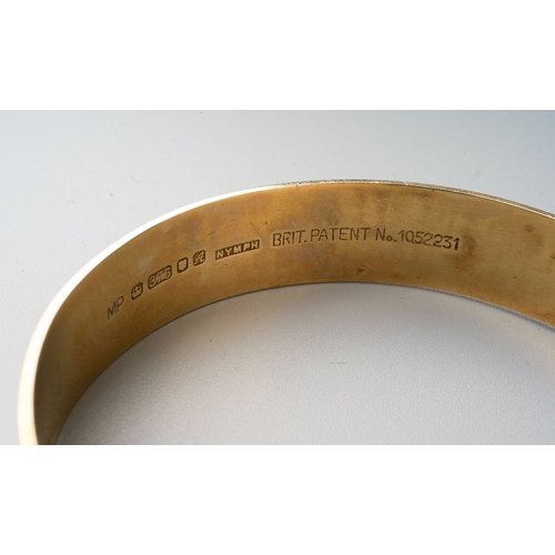 74 - 9ct gold bangle with etched detail and safety chain. Gross weight 20.8g