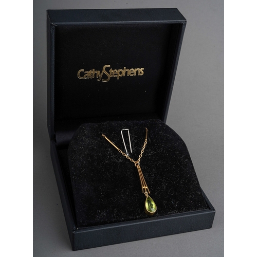 82 - Yellow metal peridot set pendant on chain. Faint 9 ct gold marks to clasp. Gross weight 5.3g