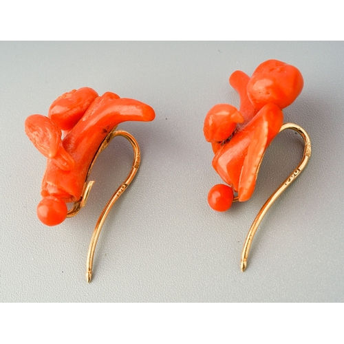 86 - A pair of antique coral earrings with antique case, each earring designed as branch and carved coral... 