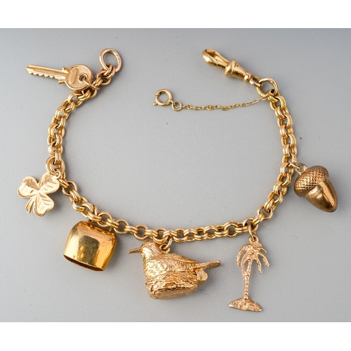 90 - A 9ct gold charm bracelet with 5 9ct charms attached. Gross weight 23.8 g