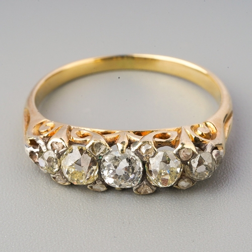 91 - A yellow metal diamond five stone ring, set with graduating old European cut diamonds, diamond point... 