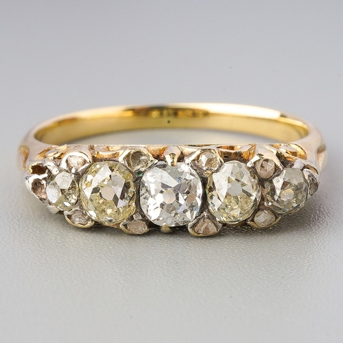 91 - A yellow metal diamond five stone ring, set with graduating old European cut diamonds, diamond point... 