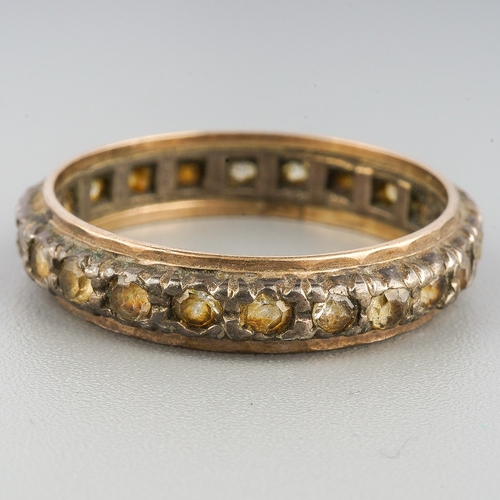 114 - A paste set yellow and white metal eternity ring, set with colourless paste, stamped sil 9ct, approx... 