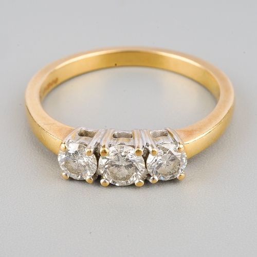 120 - An 18ct gold diamond three stone ring, set with round brilliant cut diamonds, estimated total diamon... 