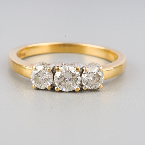 120 - An 18ct gold diamond three stone ring, set with round brilliant cut diamonds, estimated total diamon... 