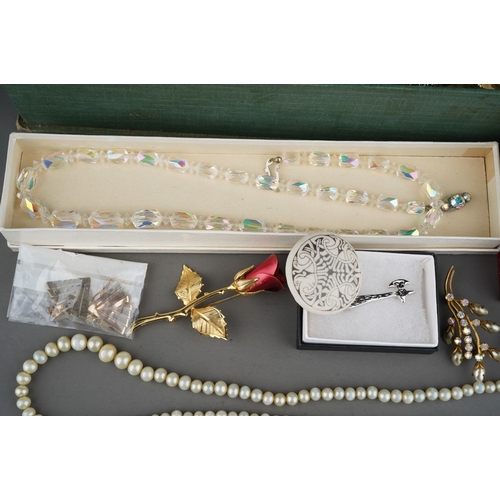 128 - Box with costume jewellery to include white metal bangles, snake necklace, silver and green stone ea... 