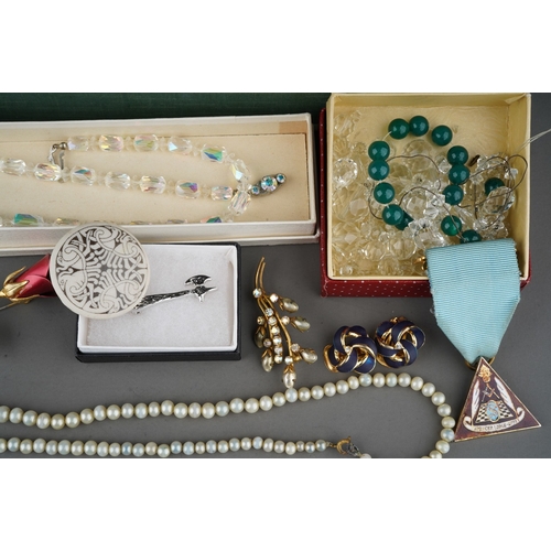 128 - Box with costume jewellery to include white metal bangles, snake necklace, silver and green stone ea... 