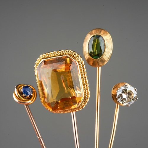 131 - Four tie pins to include yellow metal large citrene one, 14 ct green stone one, 9 ct sapphire set on... 