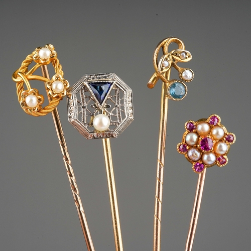 132 - Four tie pins to include yellow and white metal one in art deco style set with a pearl and blue ston... 