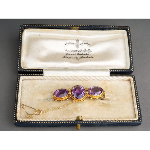 138 - 15 ct gold and 3 large amethyst set brooch in a period box. Gross weight 4.7 g