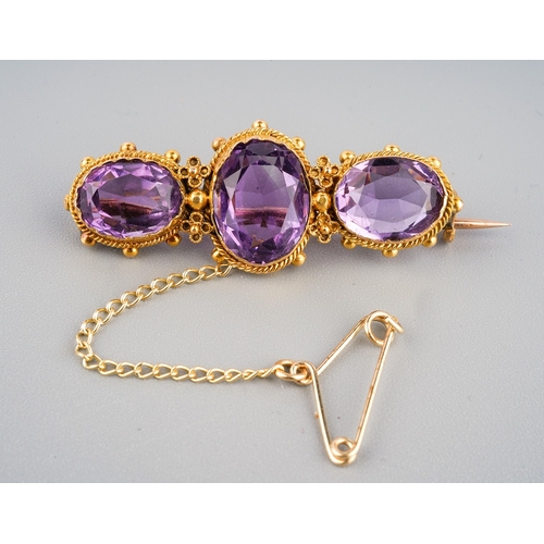 138 - 15 ct gold and 3 large amethyst set brooch in a period box. Gross weight 4.7 g