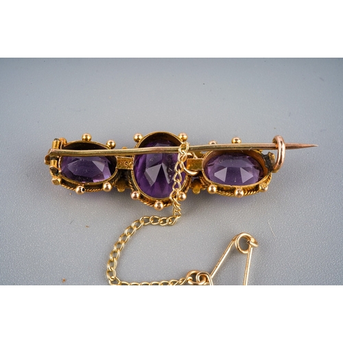 138 - 15 ct gold and 3 large amethyst set brooch in a period box. Gross weight 4.7 g