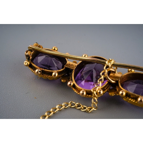 138 - 15 ct gold and 3 large amethyst set brooch in a period box. Gross weight 4.7 g