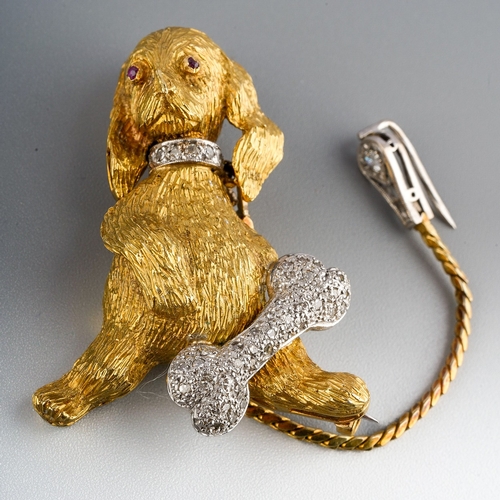 153 - An 18ct gold novelty dog brooch, designed with an articulated head with red gem set eyes, diamond se... 