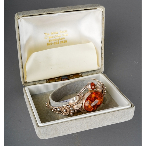 161 - Baltic amber and  white metal  bangle designed as flowers with leaves, gross weight 24.9 g