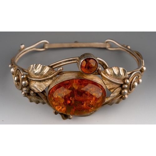 161 - Baltic amber and  white metal  bangle designed as flowers with leaves, gross weight 24.9 g