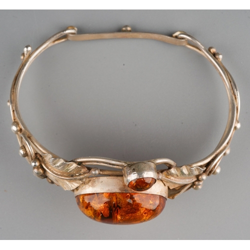 161 - Baltic amber and  white metal  bangle designed as flowers with leaves, gross weight 24.9 g