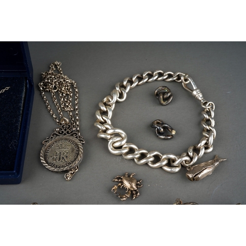 188 - Collection of silver to include silver St Nicholas on a silver chain, silver bangle, silver charm br... 