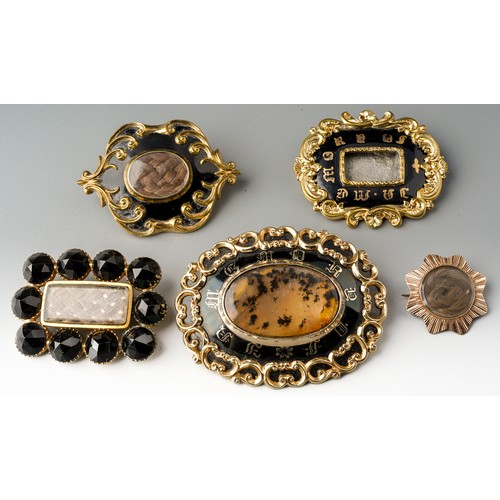 197 - Collection of mourning brooches to include 3 enamelled examples - one dated 1852 and set with moss a... 