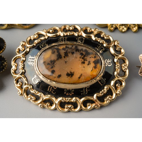 197 - Collection of mourning brooches to include 3 enamelled examples - one dated 1852 and set with moss a... 