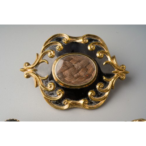 197 - Collection of mourning brooches to include 3 enamelled examples - one dated 1852 and set with moss a... 