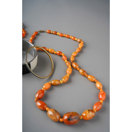 199 - Collection of Jewellery containing carnelian beads, Monet bangle, Bakelite amber type beads etc.