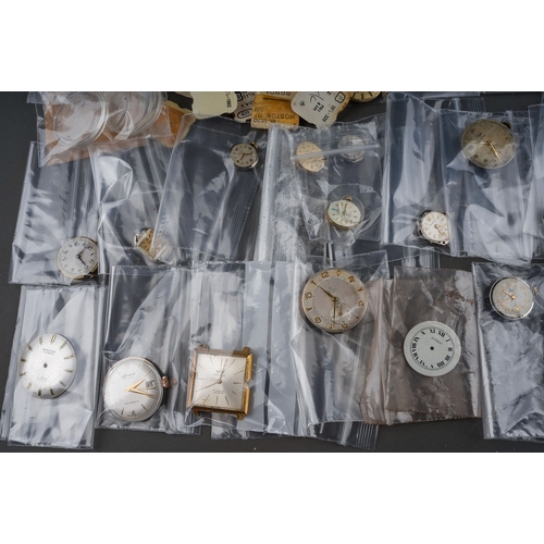 239 - Large collection of assorted watch parts - to include movements, glass, replacement parts, faces etc... 