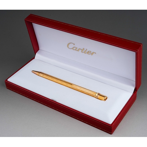 252 - Cartier - a gold-plated roller ball pen, in fitted presentation box