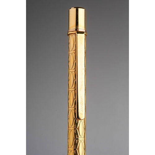 252 - Cartier - a gold-plated roller ball pen, in fitted presentation box