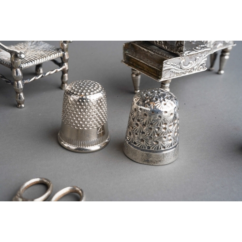 263 - A collection of small silver, white metal and plated items, comprising a miniature German white meta... 