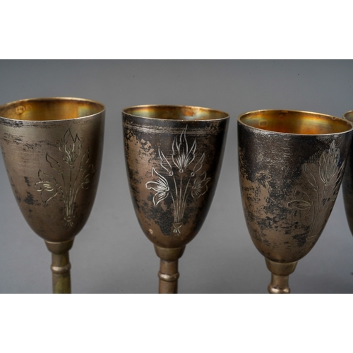 266 - A set of six early 20th Century Russian 875 standard silver tots /cups, engraved decoration, gilt in... 