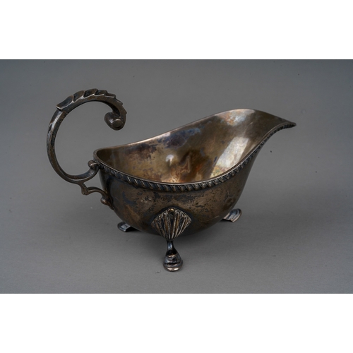 273 - A George V silver small sauceboat, gadroon border on three shell and hoof feet, C-scroll handle, hal... 