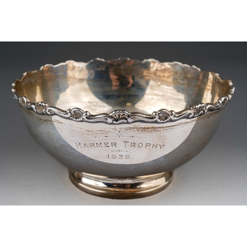 282 - A George V silver circular plain bowl with scroll and shell border, engraved MARMER TROPHY 1938, hal... 