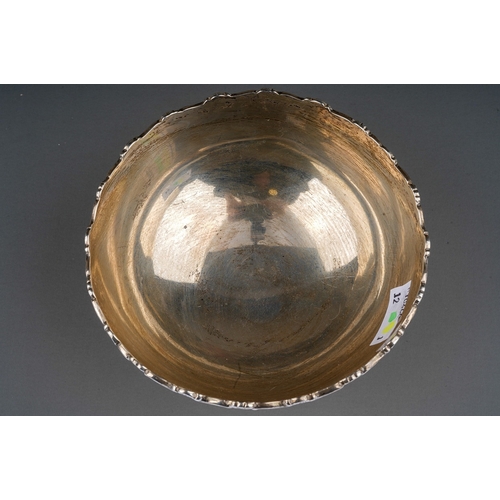 282 - A George V silver circular plain bowl with scroll and shell border, engraved MARMER TROPHY 1938, hal... 