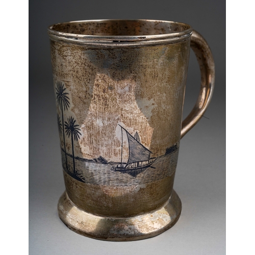 283 - A Middle Eastern white metal (low grade silver) and niello tankard, decorated with boats with palm t... 