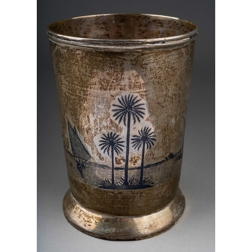 283 - A Middle Eastern white metal (low grade silver) and niello tankard, decorated with boats with palm t... 