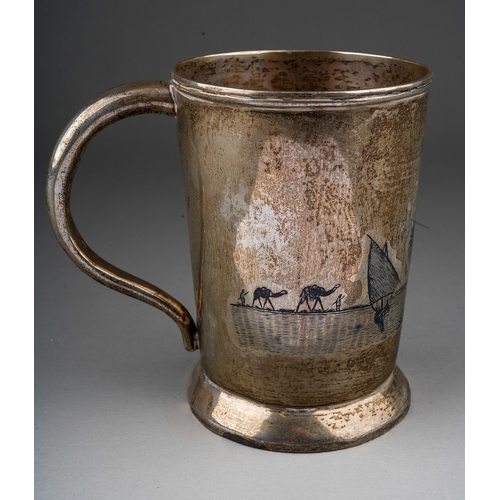 283 - A Middle Eastern white metal (low grade silver) and niello tankard, decorated with boats with palm t... 