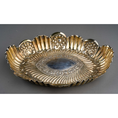 291 - A cased Victorian silver wavy rimmed oval dish, repousse decorated with foliate scrolls and fluting,... 