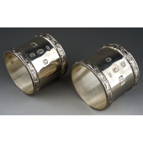 297 - A pair of Elizabeth II silver large napkin rings with raised foliate borders, hallmarked by Derby Co... 