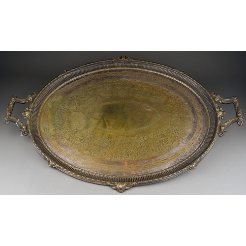 311 - A late Victorian silver plated oval twin handled tray, with engraved centre and cast rim, stamped AB... 