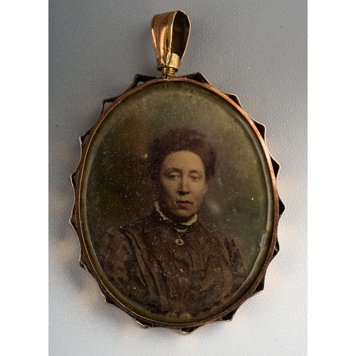 391 - An early 20th Century yellow metal pendant complete with sepia portrait photographs of WWI Cavalry t... 