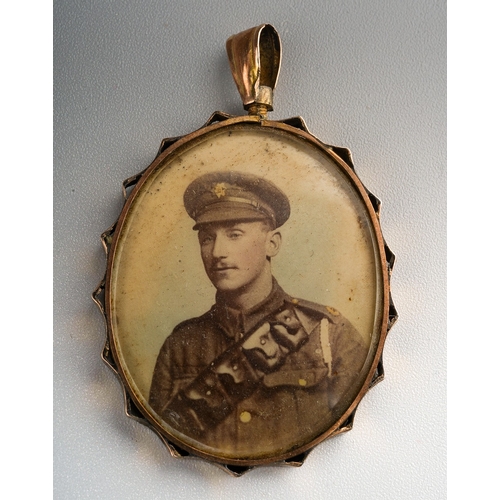 391 - An early 20th Century yellow metal pendant complete with sepia portrait photographs of WWI Cavalry t... 