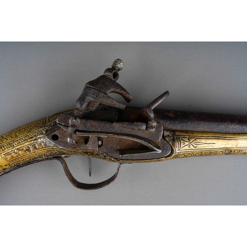 407 - A 19th century miquelet brass flint lock pistol, with stamped decoration throughout, lacks ram rod, ... 