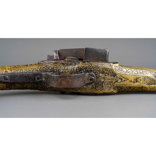 407 - A 19th century miquelet brass flint lock pistol, with stamped decoration throughout, lacks ram rod, ... 