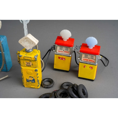 430 - A collection of five die cast and plastic toy petrol pumps, the diecast pumps with plastic tops, wor... 