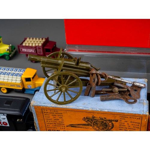 435 - A vintage boxed Schuco Telesteering tinplate clock work car with accessories together with boxed Gun... 